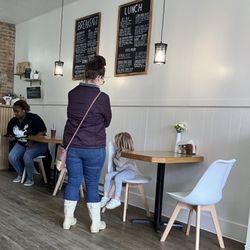 Nourish Coffee + Kitchen - Dining room with menus posted on the wall.