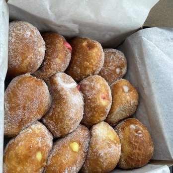 Leonard's Bakery - A dozen of fried donuts with artificial cream - Bakeries Near Me - Honolulu, Hawaii
