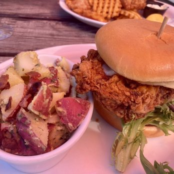 Cooper Mountain Ale Works - Cajun chicken sandwich with German potato salad. Waffle fries in the back nom nom nom - Brewpubs Near Me - Tigard, Oregon