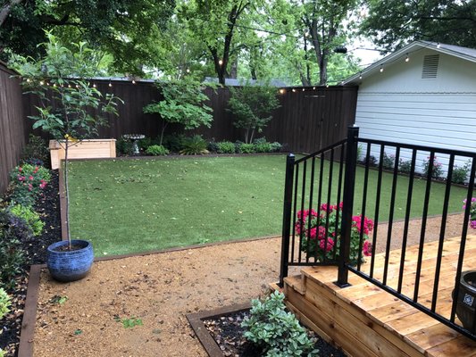 Full Backyard Remodel in Dallas - This family in Dallas could not get grass to grow in their back yard due to shade from their neighbor's large tree. We came in and installed synthetic turf and perimeter landscape beds to the whole family a yard they could enjoy all year long!