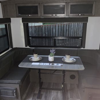Curtis Trailers - Beaverton - Rear Booth seating ~ we will have great views from this booth!! Storage area under the seats and above - RV Dealers Near Me - Aloha, Oregon