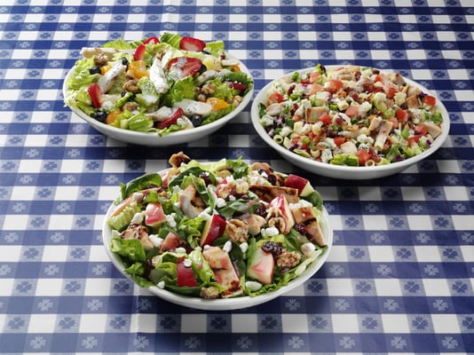 Photo of Portillo's Hot Dogs - Buena Park, CA, US. Salad trios: Chopped salad, apple walnut chicken salad, and poppy seed fruit with chicken salad.