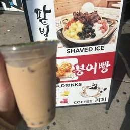 a hand holding a cup of coffee