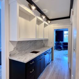 Wet bar with marble counter and custom marble backsplash design Wet bar with marble counter and custom marble backsplash design