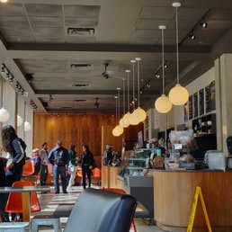 people walking through a coffee shop