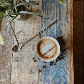 Geist Coffee - a cup of cappuccino on a wooden table - Coffee & Tea Near Me - Fishers, Indiana