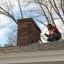 Michigan Pro Home Inspections - Kase is checking out the flashing at the chimney penetration. Verified Reviews 4.77 out of 5 on 1000's of Inspections. MichiganPro.com
