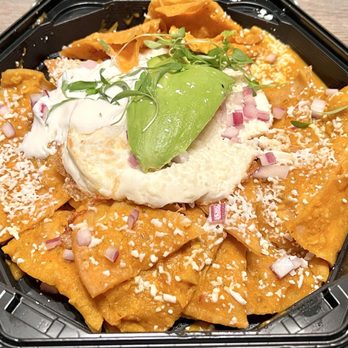 Chuponcito - Chilaquiles | Crispy tortilla chips coated in a creamy tomato-based sauce with slices of fresh avocado and an over easy egg on top. - Mexican Near Me - Aliso Viejo, California