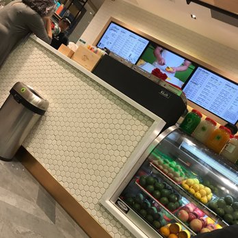 Real Fruit Bubble Tea - a man standing in front of a display case - Bubble Tea Near Me - Mississauga, Ontario