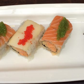 Amber - My $15 "special" roll to the left and a piece of Uni sushi. - Japanese Near Me - New York, New York