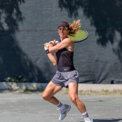 Rideau Sports Centre - Woman playing tennis on outdoor clay tennis court