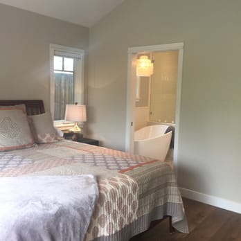 Bayview Construction - a bedroom with a bed and a chair - General Contractors Near Me - Santa Monica, California