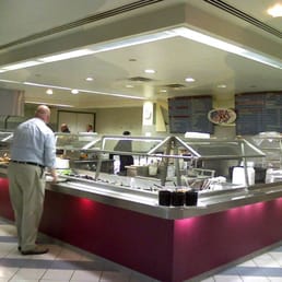 a man standing in front of a buffet a man standing in front of a buffet