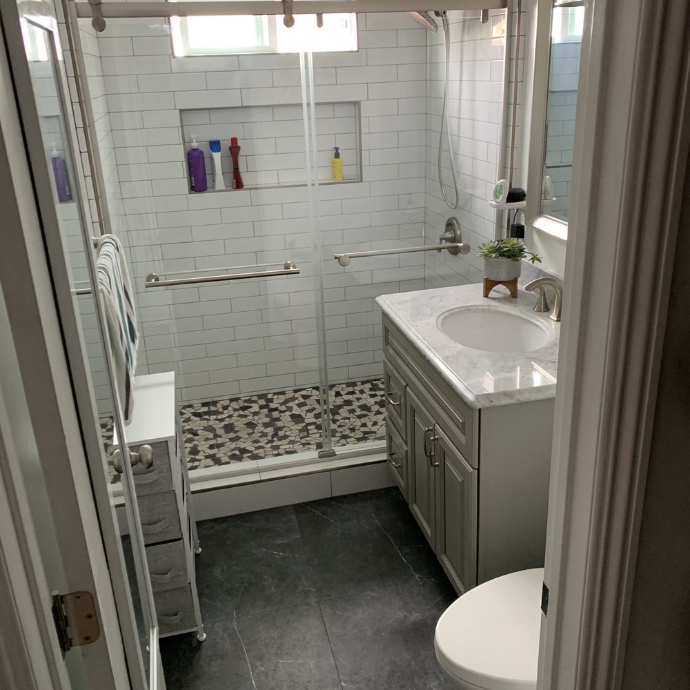 Bathroom floor work. Shower wall tile and mosaic pebble flooring. Frameless shower sliding doors. Bathroom floor work. Shower wall tile and mosaic pebble flooring. Frameless shower sliding doors.