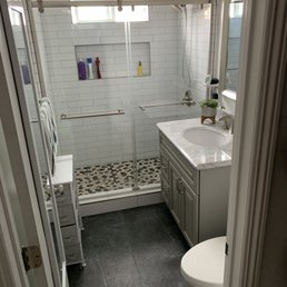 Bathroom floor work. Shower wall tile and mosaic pebble flooring. Frameless shower sliding doors.
