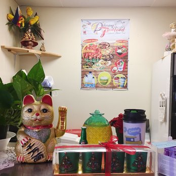 Pinoy Fast Food - a cat figurine on a counter - Filipino Near Me - Houston, Texas