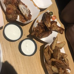 Mom's small order of Asian Zing and Caribbean Jerk wings w/ potato wedges (so good she took a bite before I snapped lol) Mom's small order of Asian Zing and Caribbean Jerk wings w/ potato wedges (so good she took a bite before I snapped lol)