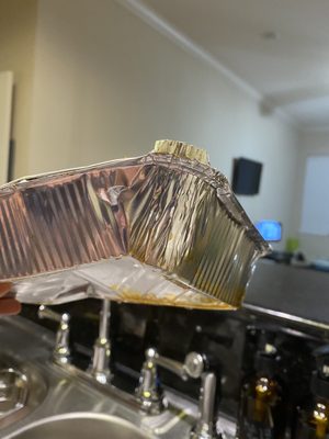 Photo of Taste of Tokyo - River Ridge, LA, US. a person holding a foil container over a sink