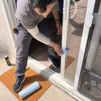 Keep On Gliding - This is Juan cleaning up the door frame after replacing the track and rollers under this sliding glass door - Door Sales/Installation Near Me - Carlsbad, California