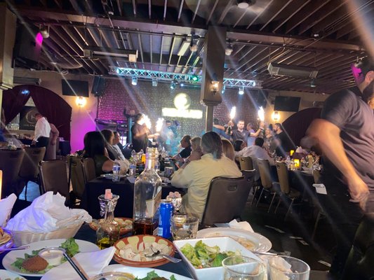 Photo of The Palace Lounge - Upland, CA, US. a man standing in front of a table full of food