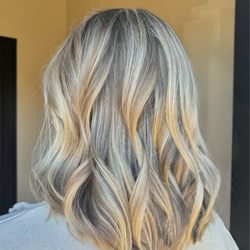 Soft dimensional blonde to create contrast and dimension. Used a 1.25 barrel curling iron to finish her new long bob haircut.