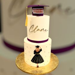 Iced By Amanda - Two tier vanilla graduation cake with edible graduation girl.
