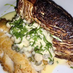 Pan roasted hake, charred cabbage, caper-butter sauce, pickled raisins