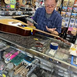 Bluegrass Musicians Supply - Owner John serving my guitar