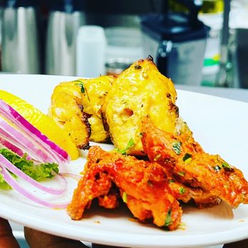 Indian Accent - a person holding a plate of food - Indian Near Me - Calgary, Alberta Indian Accent - a person holding a plate of food - Indian Near Me - Calgary, Alberta