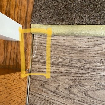 Empire Today - Cracked laminate and gap where you can see the existing floor. - Carpet Installation Near Me