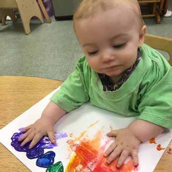 Children's Development Center - Infant painting and making a rainbow. - Child Care & Day Care Near Me - Raynham, Massachusetts