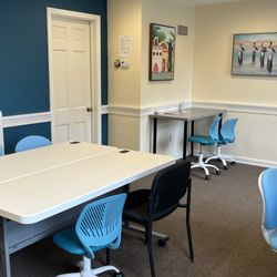 Acclaim Autism - Open therapy room with multiple activity tables at Acclaim Autism
