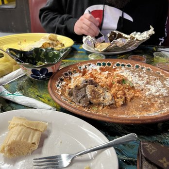 El Sorullo - a man sitting at a table with a plate of food - Mexican Near Me - Newberry, South Carolina