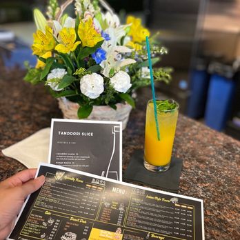 Tandoori Slice - a menu and a glass of orange juice - Pizza Near Me - Des Moines, Washington