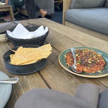 Aba - Muhammara and rosemary crisp chip things, in the basket is the amazing bread - Mediterranean Near Me - Austin, Texas Aba - Muhammara and rosemary crisp chip things, in the basket is the amazing bread - Mediterranean Near Me - Austin, Texas
