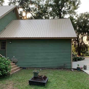 Christopher Walker & Sons - a green house with a metal roof - Painters Near Me