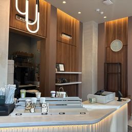 a coffee shop counter with a coffee maker a coffee shop counter with a coffee maker