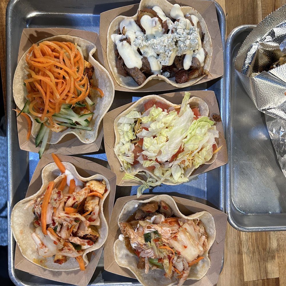 Cheesesteak taco Traditional taco Korean taco Korean tofu taco Tofu bahn mi taco Mexican corn ( barely in the pic) Cheesesteak taco Traditional taco Korean taco Korean tofu taco Tofu bahn mi taco Mexican corn ( barely in the pic)