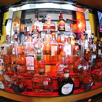 Squeeze - a large display of liquor bottles in a bar - Bars Near Me - Galveston, Texas Squeeze - a large display of liquor bottles in a bar - Bars Near Me - Galveston, Texas