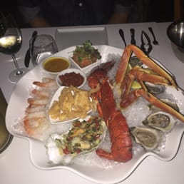 The cold seafood platter for two: shrimp, salmon sashimi, lobster, crab legs, oysters, seafood salad, with a selection of sauces