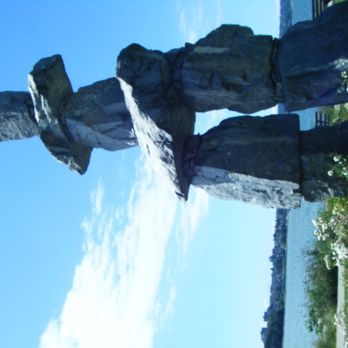 Pizza Pizza - a statue of a man standing in front of a body of water - Pizza Near Me - Winnipeg, Manitoba