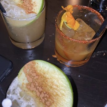 Ysabel - The Bella is made with whiskey and topped with a slice of green apple The Selena is made with tequila topped with tajin on rim - New American Near Me - West Hollywood, California Ysabel - The Bella is made with whiskey and topped with a slice of green apple The Selena is made with tequila topped with tajin on rim - New American Near Me - West Hollywood, California