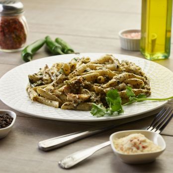 Pizza Twist - a plate of pasta on a wooden table - Pizza Near Me - Modesto, California Pizza Twist - a plate of pasta on a wooden table - Pizza Near Me - Modesto, California