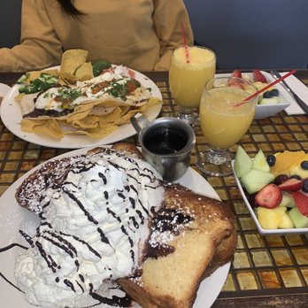 Good Eats - Brunch Menu- Juevos Rancheros and strawberry stuffed French toast which comes with a fruit bowl and a mimosa or juice . - Diners Near Me - Maspeth, New York