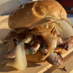 Between the Bread - ChiTown Caramelized Onions Finisher with dark Stout, Garlic Aioli, Pork Chop Sauce on a Brioche Bun