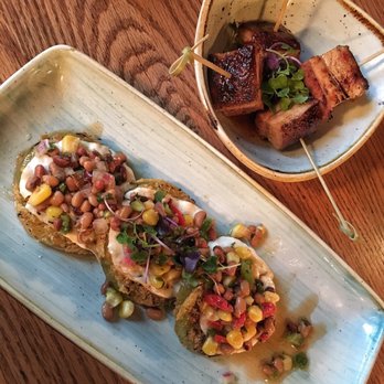 Hen Quarter - appetizers - pork belly poppers + fried green tomatoes with smoked mozzarella and pea salsa. - Southern Near Me - Alexandria, Virginia Hen Quarter - appetizers - pork belly poppers + fried green tomatoes with smoked mozzarella and pea salsa. - Southern Near Me - Alexandria, Virginia