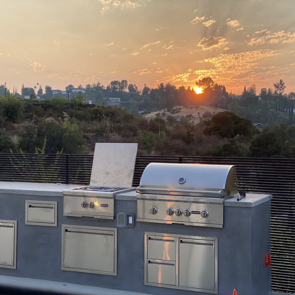 Dreamscape Development - an outdoor kitchen with a sunset in the background - Masonry/Concrete Near Me - San Fernando Valley, California