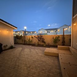 Montesinos Landscape and Concrete - Backyard at night with string lights