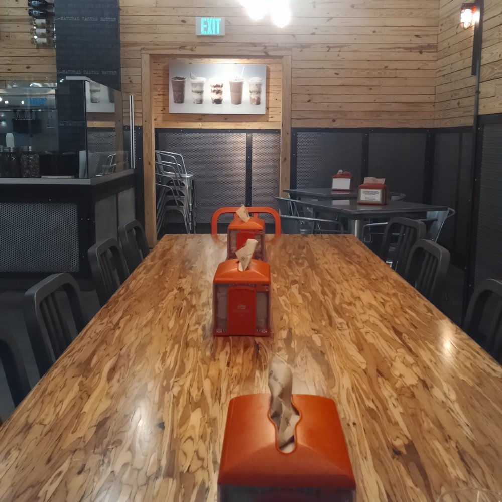 BurgerFi - Long dining table, good atmosphere. Great for groups. - Burgers Near Me - Silver Spring, Maryland BurgerFi - Long dining table, good atmosphere. Great for groups. - Burgers Near Me - Silver Spring, Maryland