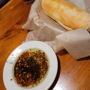 Johnny Carino's - Complimentary bread with toasted olive oil dipping sauce - Italian Near Me - Albany, Oregon Johnny Carino's - Complimentary bread with toasted olive oil dipping sauce - Italian Near Me - Albany, Oregon